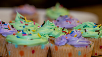 Close up view of colorful freshly baked cup cakes with selective focus.