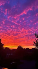 Vibrant Sunset Sky Over Suburban Houses