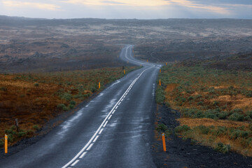 Scenic winding high way through the tundra fields in rural Iceland