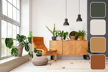 Interior of living room with green plants, commode and armchair