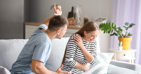 Angry husband scolding his wife at home