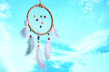 Beautiful dream catcher hanging against blue sky