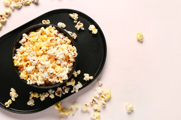 Bowl with tasty popcorn on white background