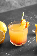 Glass of tasty mai tai cocktail on black background