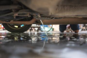 Car air conditioner cleaning with drainage water dripping underneath.