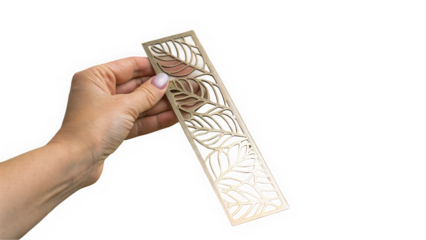A hand holding an intricate metal bookmark with a leaf design, perfect for nature lovers and avid readers.