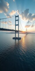 Obraz premium A majestic suspension bridge spanning a serene body of water, its cables and towers a testament to engineering prowess