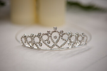 Sparkling silver bridal tiara isolated on a white table © Tanya