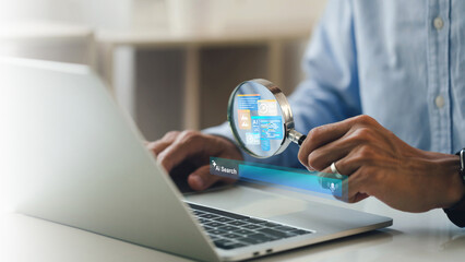 AI searching concept. artificial intelligence tool, Businessman holding a magnifying glass an AI icon and a Search engine bar on laptop. Data search optimization by artificial intelligence technology