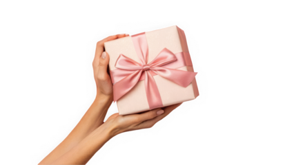 Elegant hands holding a beautifully wrapped gift box with a pink satin ribbon.