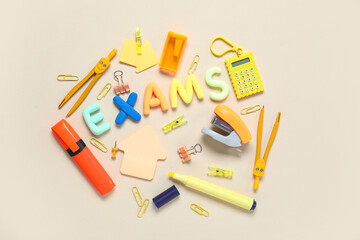Composition with word EXAMS made of colorful letters and different stationery on color background
