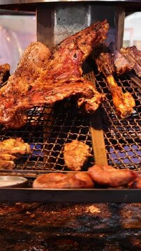 Uruguay, Montevideo market restaurants offering traditional slow cooked asado parilla grilled meat that includes chorizo beef, kidneys and chicken.