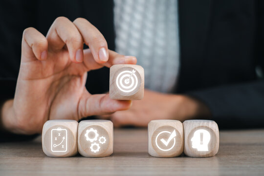 Wooden blocks illustrating the Plan Do Check Act cycle, symbolizing continuous improvement and strategic business planning.