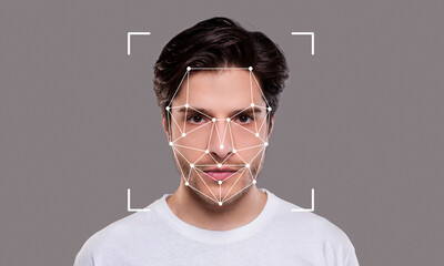 A young man poses against a neutral background while facial recognition technology is applied. The highlights of his facial features are outlined with points and lines, emphasizing identification.