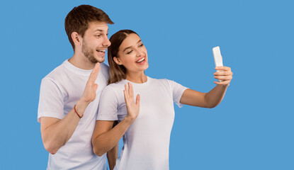 Hello. Excited lovely couple chatting online on cell phone and waving hands, purple background, banner