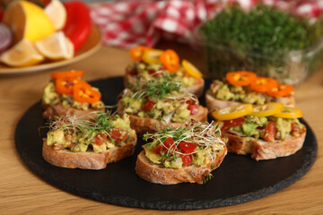 Tasty vegan bruschettas on table in kitchen, closeup