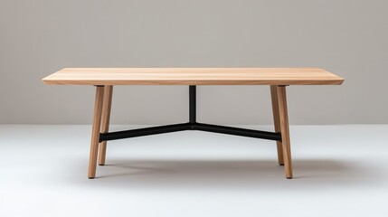 Fototapeta premium Minimalist wooden dining table with a black metal frame stands in a neutral studio environment.