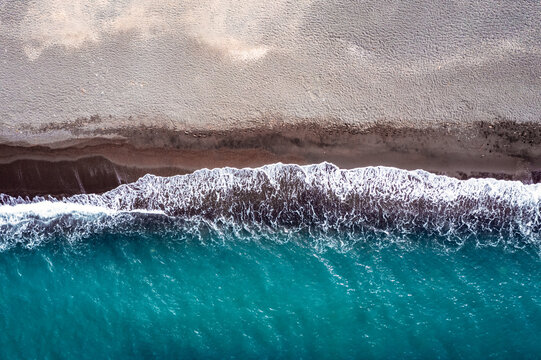 Aerial view of black sand beach ans sea, Santorini island, Greece
