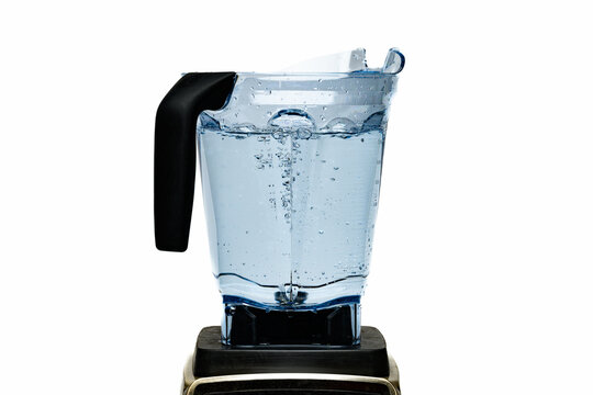 Bubbling water in a clear plastic blender against a white backdrop