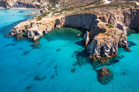 Aerial view of rocky coastline and turquoise sea, Milos island, Greece