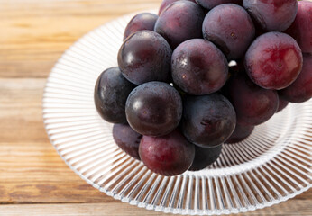 Fresh Japanese Pione Grapes Placed on a Wooden Surface