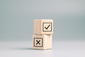 Correct and Incorrect check mark on stack of wooden cubes, right or wrong, decision, vote, and...