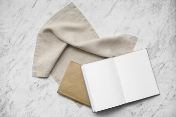 Grey napkin with books on white grunge background