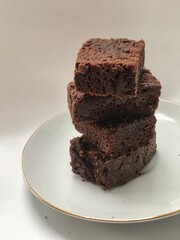 stake of chocolate brownies on white plate