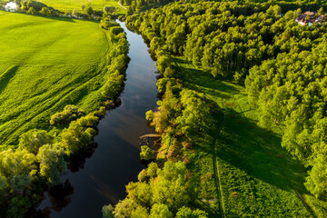 Scenic aerial view of green landscape with small river
