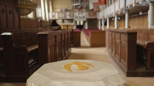 The interior of Codlea's fortified church, Romania, showcases Gothic architecture, vaulted ceilings, wooden pews, and stone walls, reflecting its serene and historic charm.