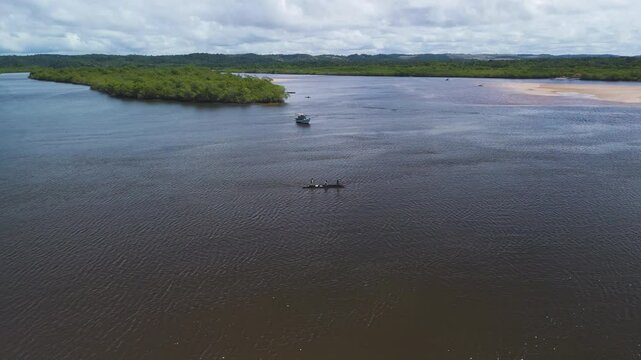 Panoramic drone shot circling a fishing boat on the De Contas river in Brazil