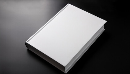 Fototapeta premium White hard cover book, isolated on black background