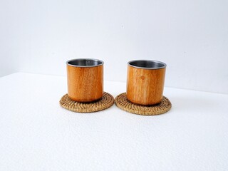 handicrafts from leftover wood in the form of glasses and cups. Aesthetic wooden glasses are suitable for cafes, restaurants and homes. on a white background