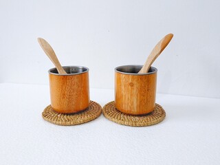 handicrafts from leftover wood in the form of glasses and cups. Aesthetic wooden glasses are suitable for cafes, restaurants and homes. on a white background