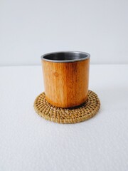 handicrafts from leftover wood in the form of glasses and cups. Aesthetic wooden glasses are suitable for cafes, restaurants and homes. on a white background