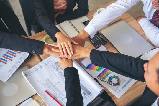 Diversity business partner people teamwork holding hands together power of tag team. Multiethnic Teamwork friendship group brainstorming togetherness. Business people team holding hands Solidarity.