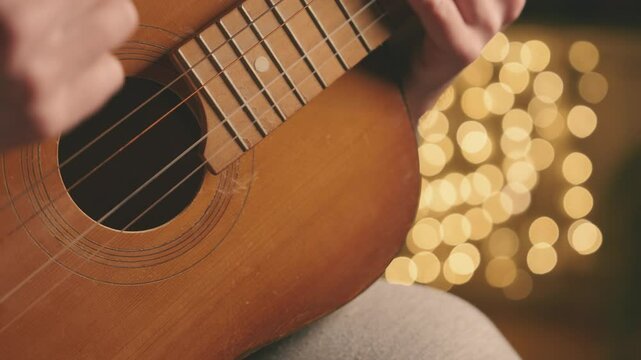 Acoustic Guitar Missing String Close Up, Musician Playing Incomplete Instrument with Golden Bokeh Lights