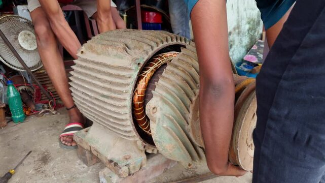 Repairman fixes an electrical dynamo by aligning