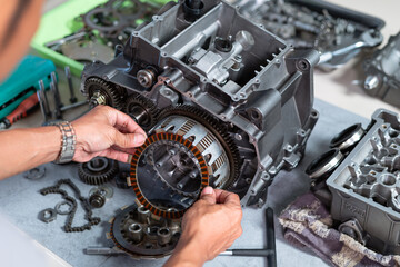 Maintenance of clutch plate replacement by technician, engineer is removing the clutch plate to measure clearance or replace it.