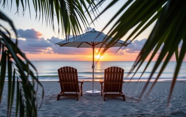 A tranquil beach scene at sunrise with two wooden lounge chairs positioned under a white umbrella.
