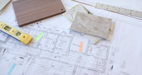 Planning construction, architectural blueprints with tile samples and measuring tools on desk