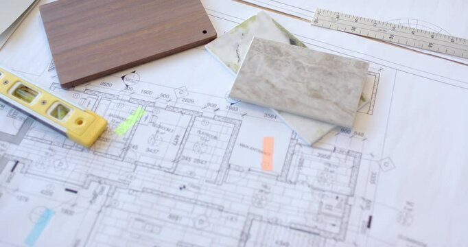 Planning construction, architectural blueprints with tile samples and measuring tools on desk