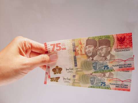 Woman Holding and Showing Seventy-five thousand rupia Money.
Limited edition Rupiah Banknotes