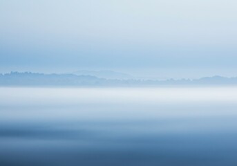 Obraz premium Ethereal misty landscape, soft blue and white gradient, minimalist horizon, atmospheric perspective, dreamy ambiance, serene cloudscapes