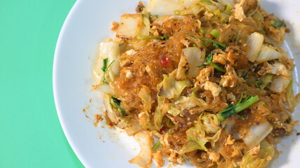 stir fried sukiyaki with egg and pork on white plate