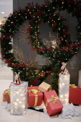 Chrismast decoration details with green leafy plants, gift boxes and reindeer toy