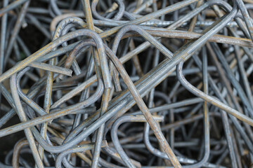 A pile of a lot of slightly rusty cast iron or rebar for a square-shaped building, the photo was taken close up with a high angle