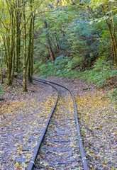 a narrow gauge railway with a solid foundation in a mountainous area in early autumn with panoramic views