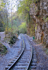 a narrow gauge railway with a solid foundation in a mountainous area in early autumn with panoramic views