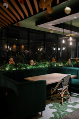 Christmas decoration details on a public vintage restaurant for holiday ambience with hanging lamp and table set